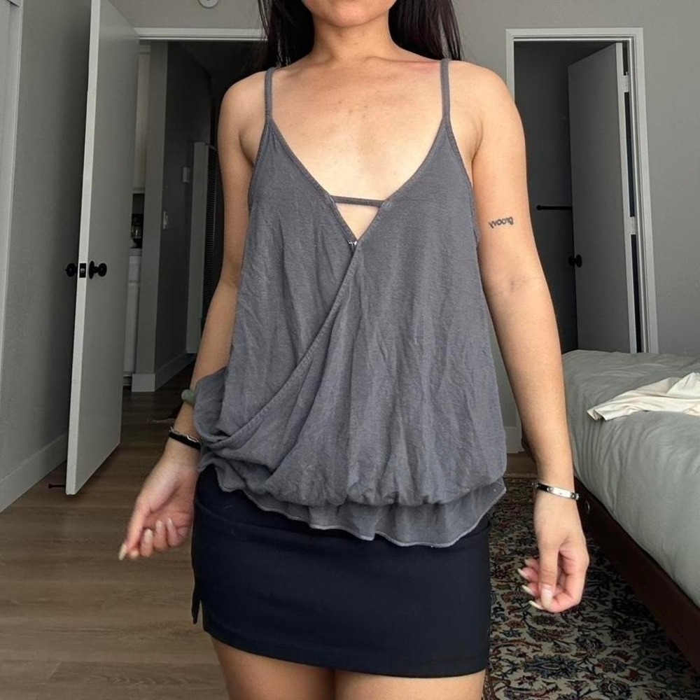 Grey Tahari blouse with ruffle detail and tie back. Size: S